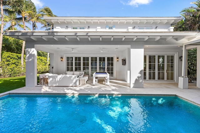 rear view of house with an outdoor hangout area, a patio area, a ceiling fan, and an outdoor pool