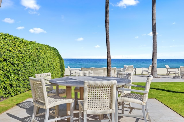 view of patio / terrace featuring outdoor dining area and a water view