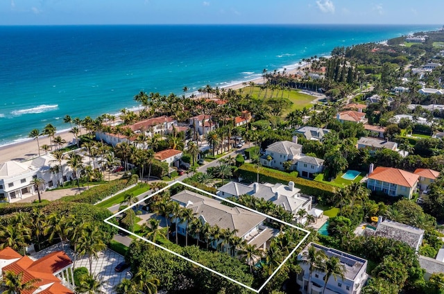 drone / aerial view featuring a water view, a residential view, and a view of the beach