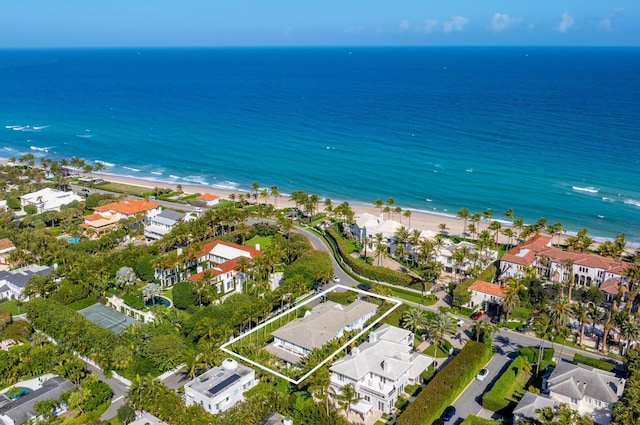 drone / aerial view with a beach view, a water view, and a residential view