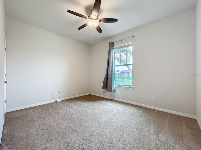 empty room featuring carpet, baseboards, and a ceiling fan