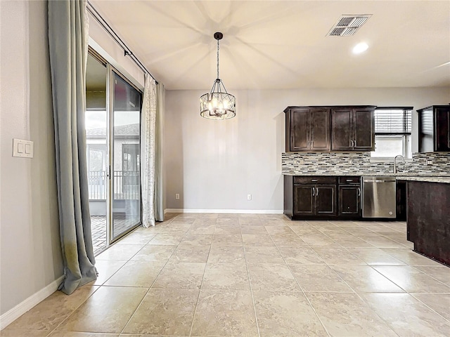 kitchen featuring visible vents, light countertops, stainless steel dishwasher, tasteful backsplash, and pendant lighting