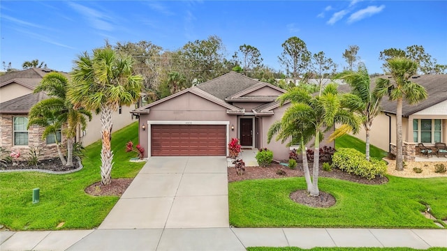 ranch-style home with an attached garage, driveway, a front yard, and stucco siding