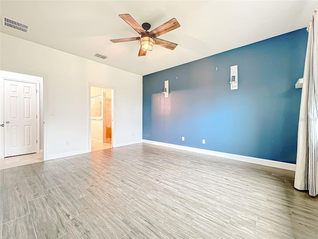 unfurnished bedroom with light wood finished floors, visible vents, baseboards, and ceiling fan