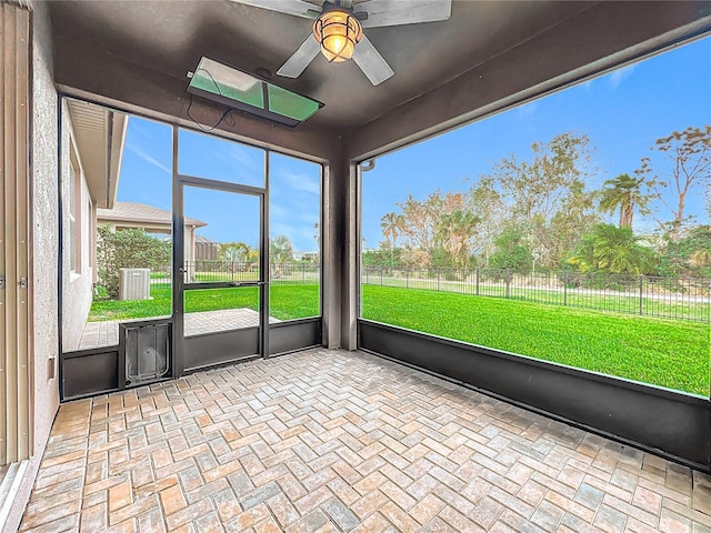 unfurnished sunroom with a ceiling fan