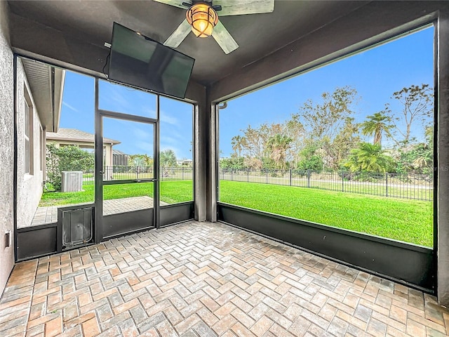 unfurnished sunroom with a ceiling fan