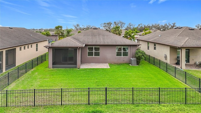 rear view of property featuring stucco siding, a fenced backyard, central AC, and a yard