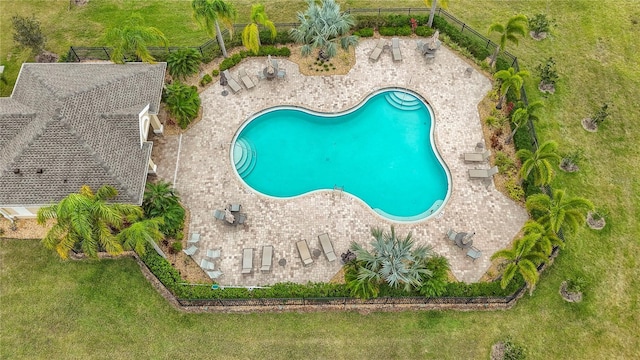 view of pool featuring a patio area, fence, and a lawn