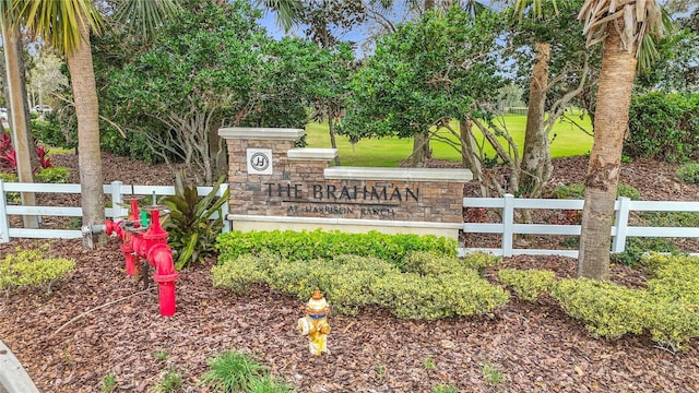 community / neighborhood sign with fence