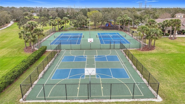 view of sport court with community basketball court, fence, playground community, and a yard