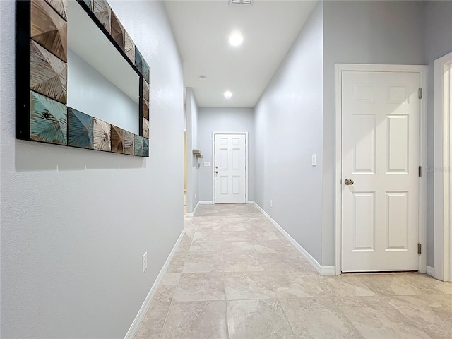 corridor with recessed lighting, visible vents, and baseboards