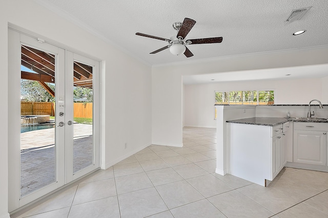 kitchen with plenty of natural light, french doors, visible vents, and a sink