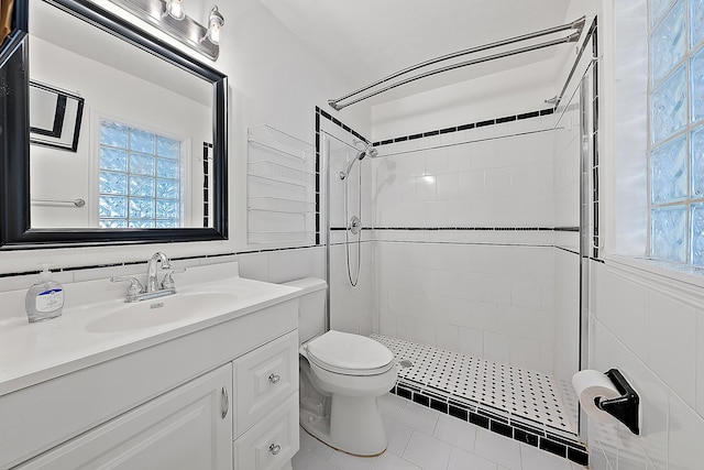 full bath with toilet, a stall shower, a wealth of natural light, and vanity