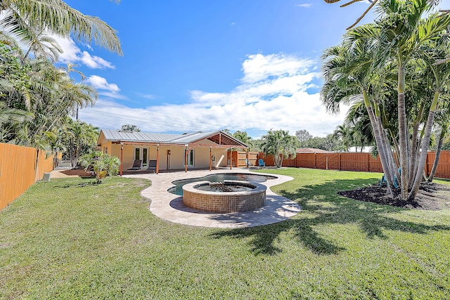 view of yard featuring a fire pit, a patio area, and a fenced backyard