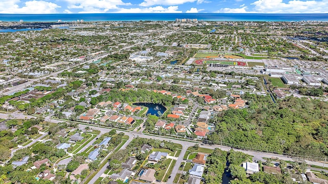 birds eye view of property with a water view and a residential view