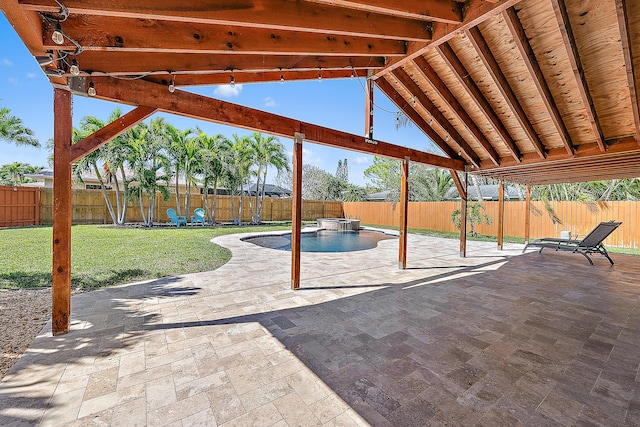 view of patio / terrace with a pool with connected hot tub and a fenced backyard