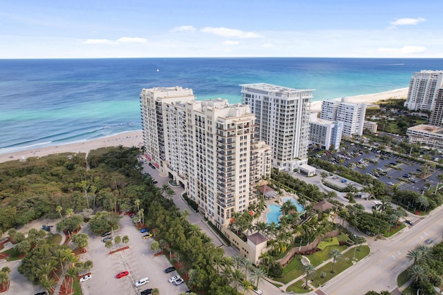 bird's eye view featuring a city view, a water view, and a beach view