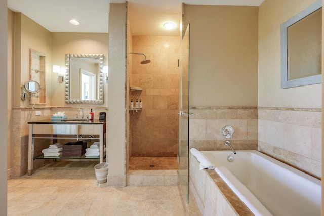 bathroom with a tile shower, a garden tub, vanity, and tile patterned floors