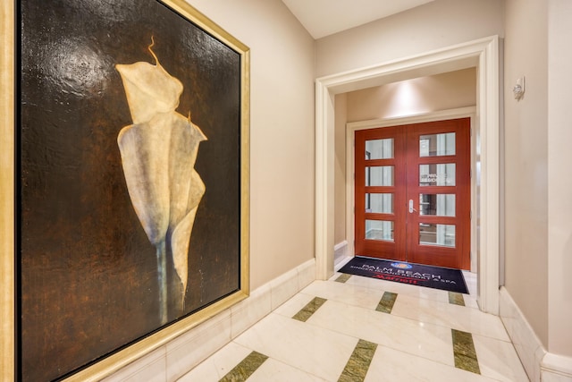 foyer featuring tile patterned flooring and baseboards