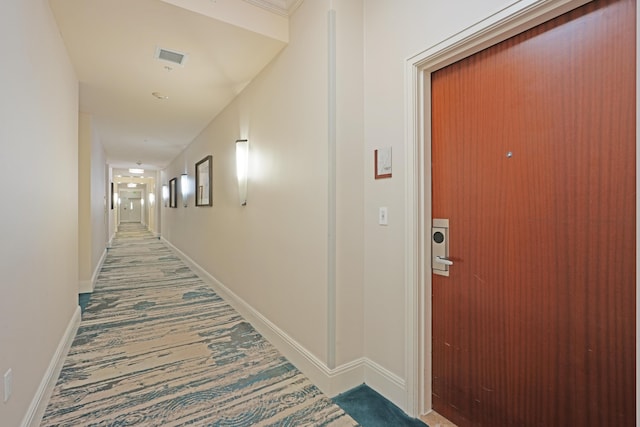 hallway featuring visible vents and baseboards