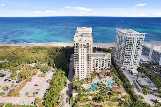 bird's eye view with a water view and a beach view