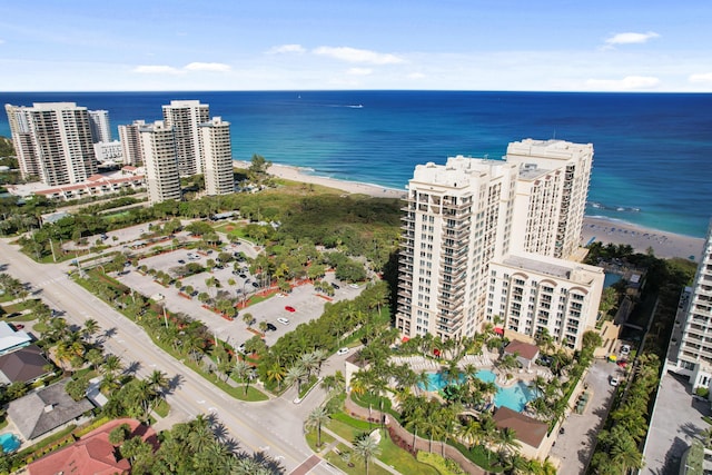 aerial view featuring a water view, a beach view, and a city view