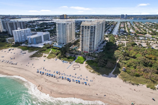 birds eye view of property featuring a view of the beach, a water view, and a view of city