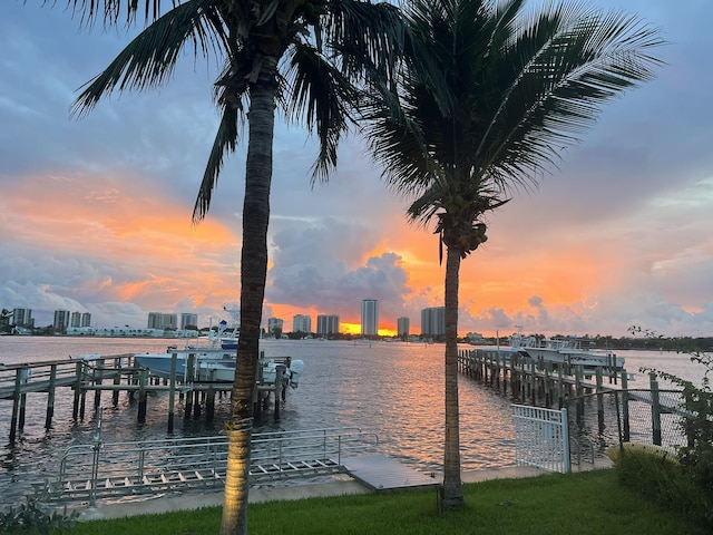 view of dock featuring a water view and a city view