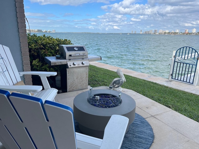 view of patio / terrace featuring a city view, a water view, and grilling area