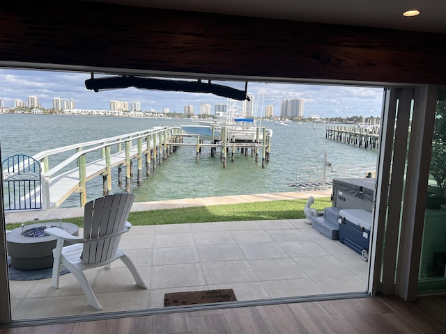 view of dock with a view of city, a water view, and boat lift