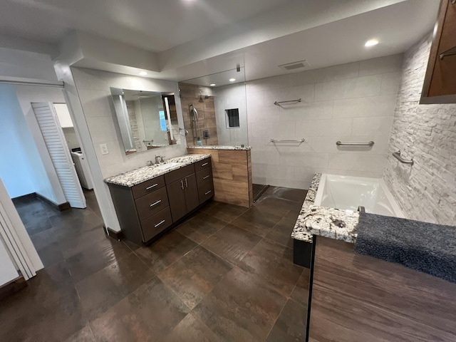 bathroom with tile walls, visible vents, vanity, a walk in shower, and a bath