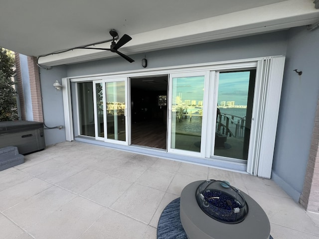 view of patio / terrace featuring ceiling fan and a hot tub