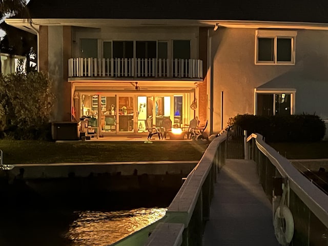 rear view of property featuring a patio, a balcony, and stucco siding