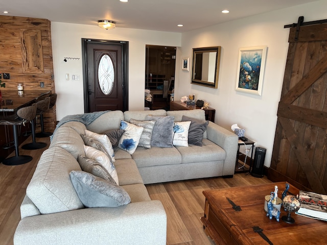 living area featuring recessed lighting, wood finished floors, and a barn door