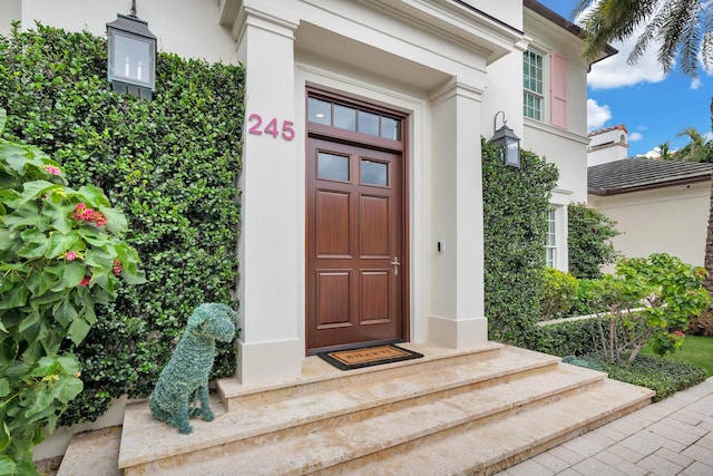 entrance to property featuring stucco siding