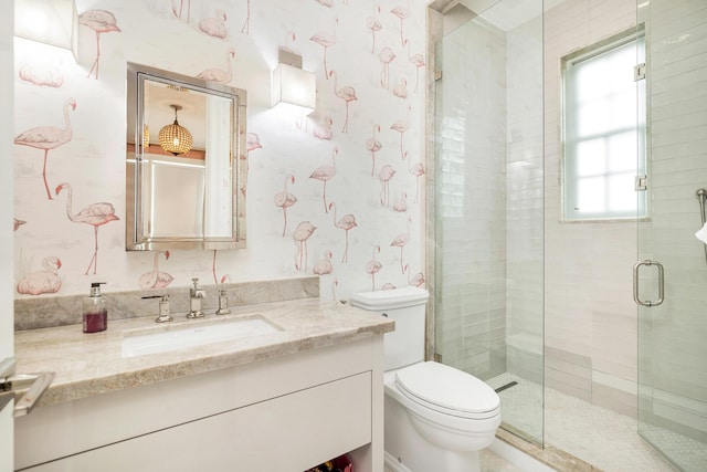 full bathroom with a shower stall, vanity, toilet, and wallpapered walls