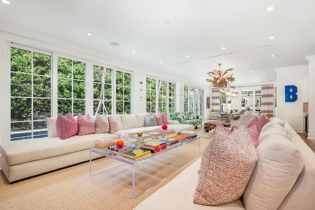 living area featuring recessed lighting, an inviting chandelier, and crown molding