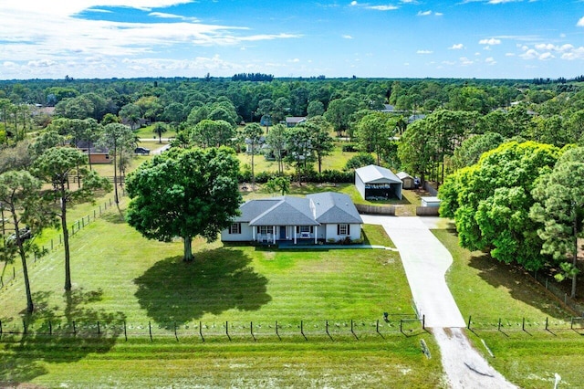 aerial view featuring a rural view and a wooded view