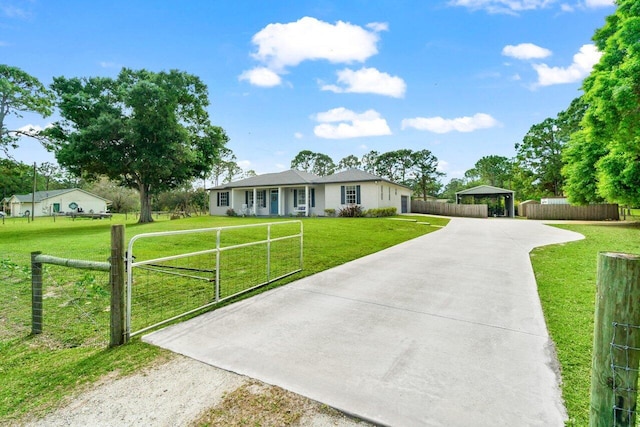 ranch-style house with concrete driveway, a front yard, fence, and a gate