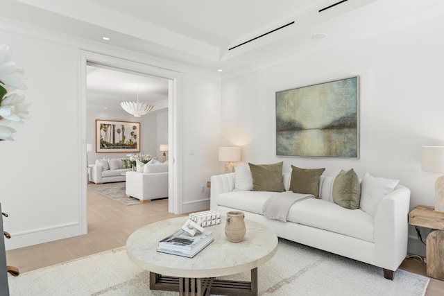 living room with baseboards, wood finished floors, crown molding, a chandelier, and recessed lighting