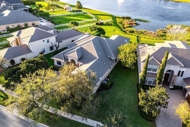 drone / aerial view with a residential view and a water view