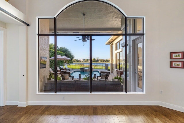 details featuring a ceiling fan, baseboards, and wood finished floors