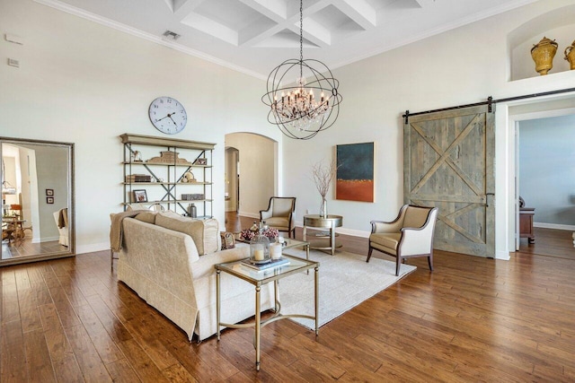 living room featuring a barn door, coffered ceiling, visible vents, a towering ceiling, and wood-type flooring