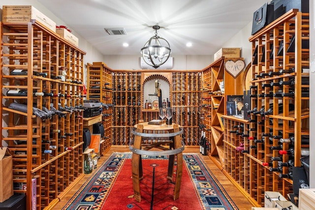 wine room with visible vents and a notable chandelier