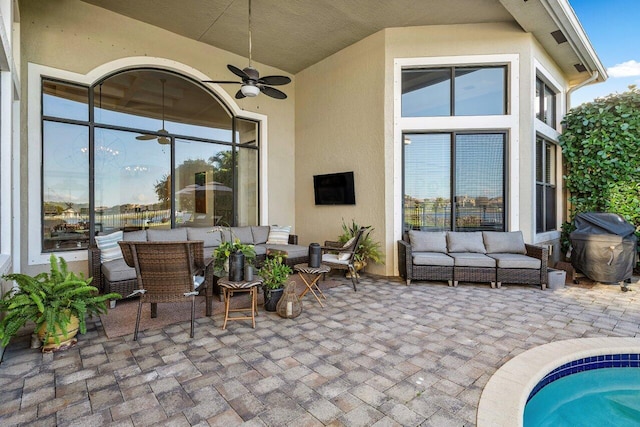 view of patio with grilling area, outdoor lounge area, and a ceiling fan