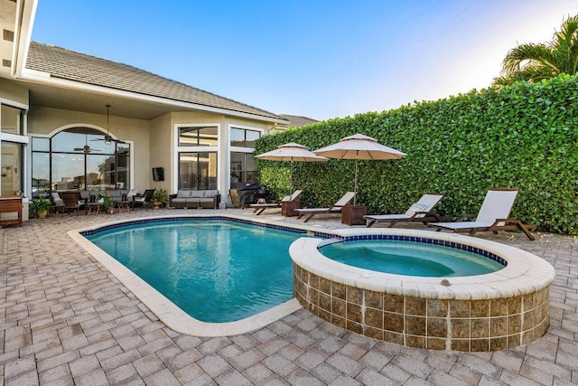 view of pool with outdoor dining space, a pool with connected hot tub, and a patio area