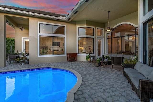 pool with outdoor lounge area and a patio