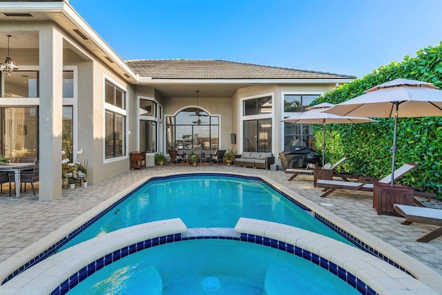 view of pool with outdoor lounge area, a patio area, a pool with connected hot tub, and outdoor dining area