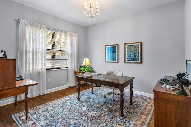 home office with a chandelier, baseboards, and wood finished floors