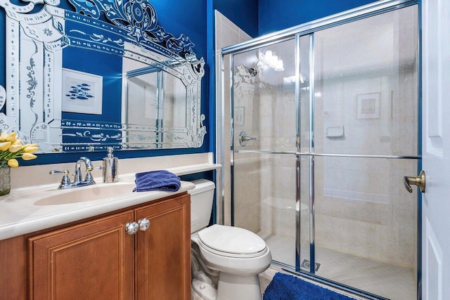 full bathroom with toilet, a shower stall, and vanity